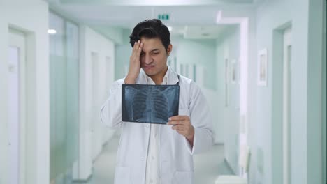 Confused-Indian-doctor-checking-X-ray-report