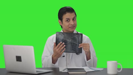 Indian-doctor-explaining-X-ray-report-to-the-camera-Green-screen
