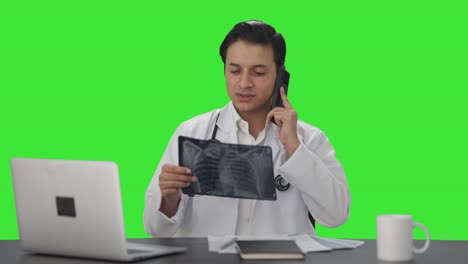 Indian-doctor-explaining-X-ray-report-on-phone-Green-screen