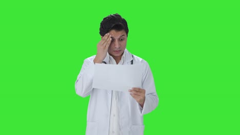 Stressed-Indian-doctor-checking-medical-reports-Green-screen