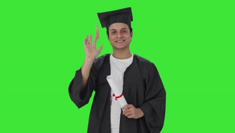 Happy-Indian-college-student-waving-Hi-to-the-camera-Green-screen