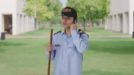 Indian-security-guard-talking-on-phone