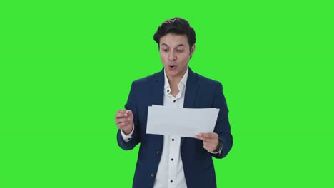 Happy-Indian-manager-checking-reports-Green-screen