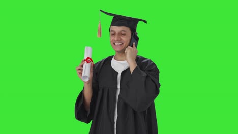Happy-Indian-college-talking-on-call-after-graduation-Green-screen