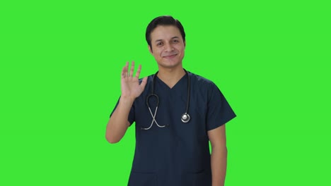 Happy-Indian-doctor-waving-Hi-to-the-camera-Green-screen
