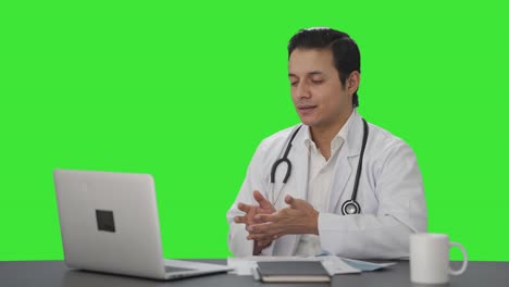 Sad-Indian-doctor-talking-on-a-video-call-Green-screen