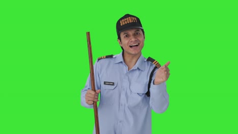 Happy-Indian-security-guard-telling-directions-to-someone-Green-screen