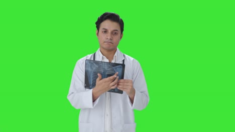 Sad-Indian-doctor-explaining-X-ray-report-to-patient-Green-screen