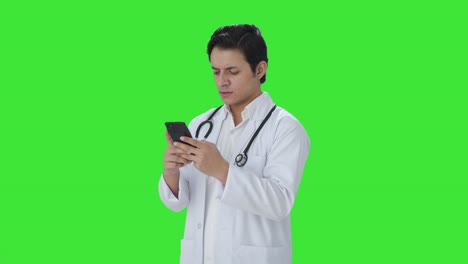 Angry-Indian-doctor-chatting-on-phone-Green-screen