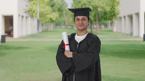 Portrait-of-Happy-Indian-graduate-student-standing-crossed-hands