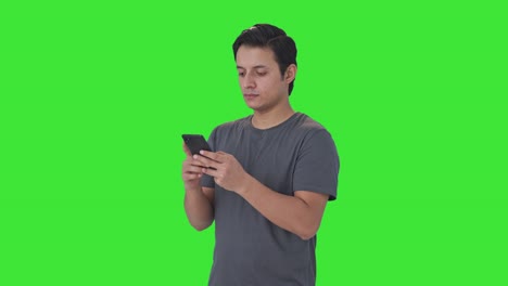 Indian-man-chatting-with-someone-Green-screen