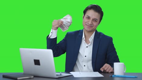 Happy-Indian-businessman-using-money-as-fan-Green-screen
