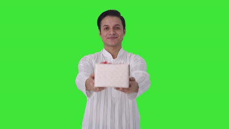 Happy-Indian-man-giving-a-gift-to-camera-Green-screen