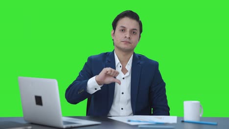 Disappointed-Indian-businessman-showing-thumbs-down-Green-screen