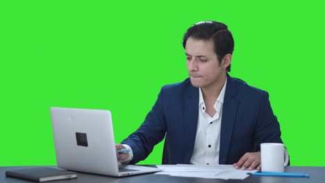 Confused-Indian-corporate-employee-working-on-laptop-Green-screen