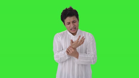 Sick-Indian-man-suffering-from-hand-pain-Green-screen