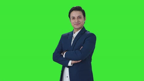 Portrait-of-Happy-Indian-businessman-standing-crossed-hands-Green-screen