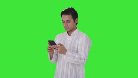 Indian-man-talking-to-someone-on-chat-Green-screen