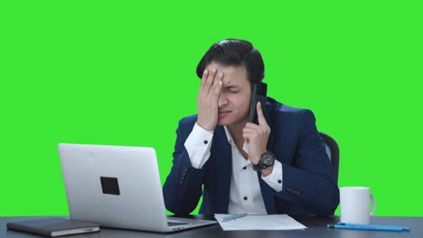 Stressed-Indian-manager-talking-on-phone-Green-screen