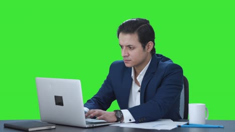 Stressed-Indian-corporate-employee-working-on-laptop-Green-screen