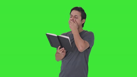Tired-and-lazy-Indian-man-reading-a-book-Green-screen