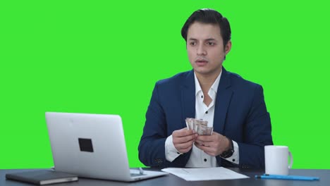 Upset-Indian-businessman-counting-money-Green-screen