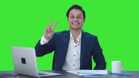Happy-Indian-businessman-showing-victory-sign-Green-screen
