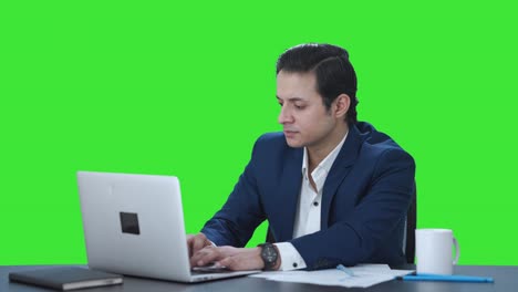 Tired-Indian-corporate-employee-working-on-laptop-Green-screen