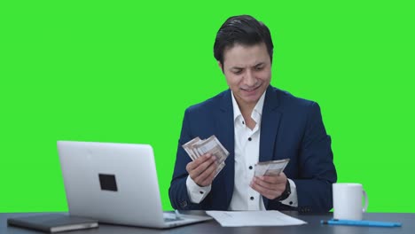 Happy-Indian-businessman-counting-money-Green-screen