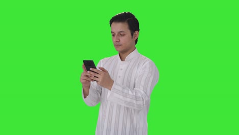 Indian-man-chatting-with-someone-Green-screen