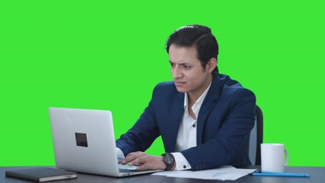 Angry-Indian-corporate-employee-working-on-laptop-Green-screen