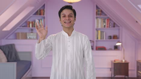 Happy-Indian-man-waving-hello-to-the-camera
