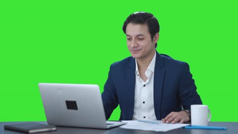 Happy-Indian-employee-starting-working-on-laptop-Green-screen