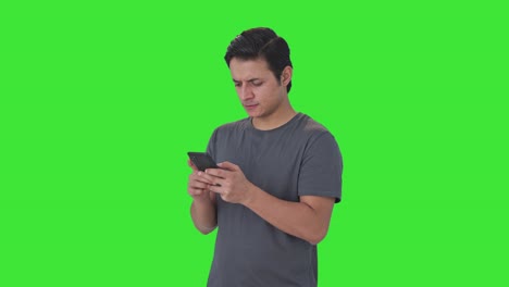 Frustrated-Indian-man-chatting-with-someone-Green-screen