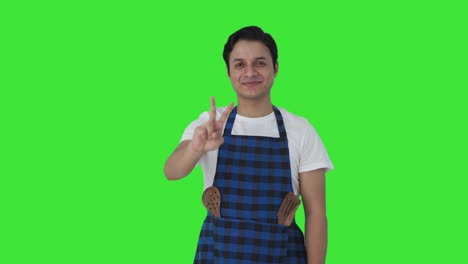 Happy-Indian-cook-showing-victory-sign-Green-screen