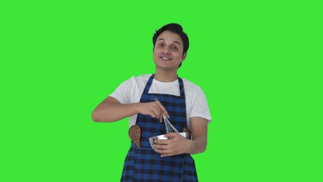 Happy-Indian-cook-telling-recipe-while-making-food-Green-screen