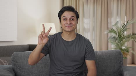 Happy-Indian-man-showing-victory-sign