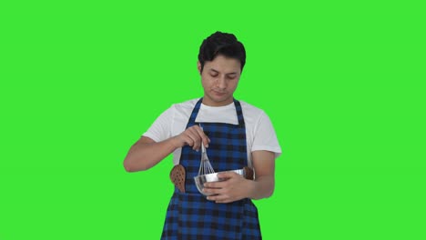 Indian-cook-whisking-flour-in-bowl-Green-screen