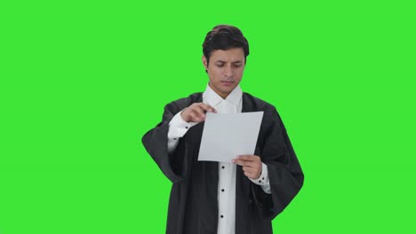 Indian-lawyer-reading-contracts-and-papers-Green-screen