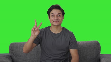 Happy-Indian-man-showing-victory-sign-Green-screen