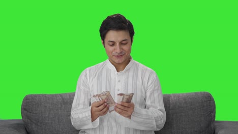 Happy-Indian-man-counting-money-Green-screen