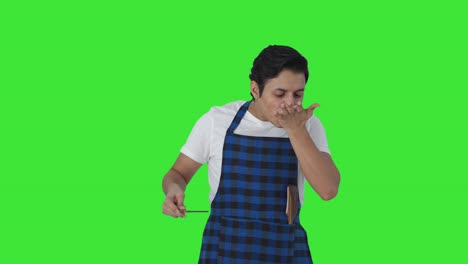Happy-Indian-cook-tasting-good-food-and-giving-chef-kiss-Green-screen