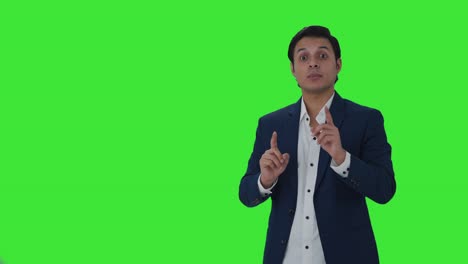 Indian-journalist-pointing-to-Copy-Space-and-talking-Green-screen