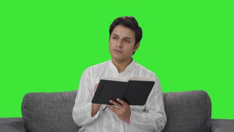 Confused-Indian-man-writing-a-diary-Green-screen