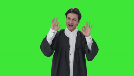 Happy-Indian-lawyer-showing-okay-sign-Green-screen