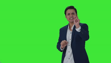 Angry-Indian-journalist-pointing-to-Copy-Space-and-shouting-Green-screen