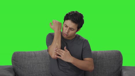 Indian-man-putting-bandage-on-wound-Green-screen