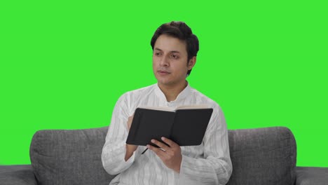 Indian-man-writing-a-diary-Green-screen