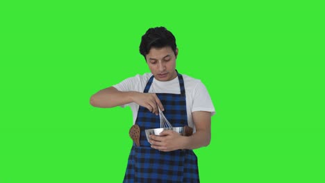 Serious-Indian-cook-telling-recipe-while-making-food-Green-screen