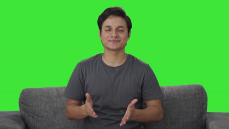 Happy-Indian-man-doing-breathe-in-breathe-out-exercise-Green-screen